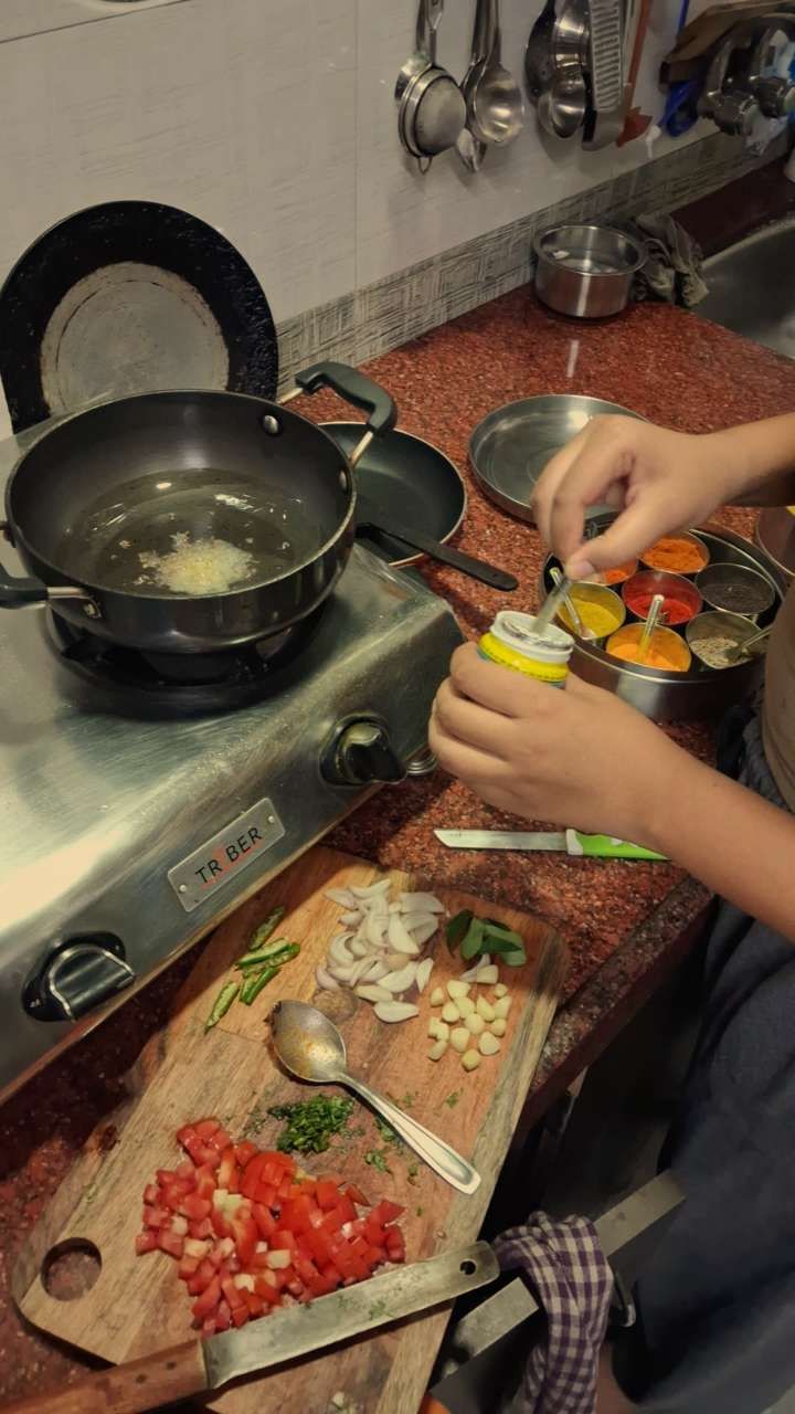 Preparing an everyday meal with vegetables and spices in a home kitchen