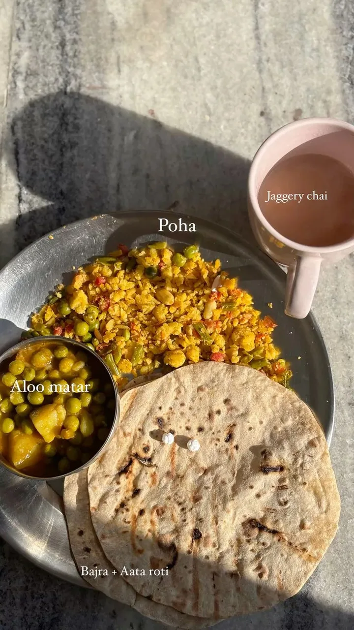 Indian meal with poha, aloo matar, roti and jaggery chai